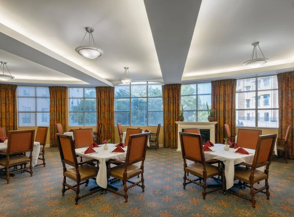 upscale dining area with multiple tables at Querencia's Assisted Living building