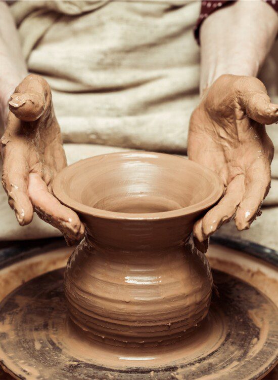 hands making pottery